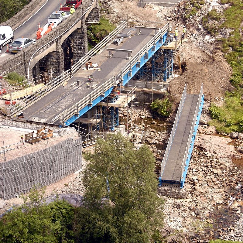 Mabey Hire vehicle beam bridge flat top next to bridge over river