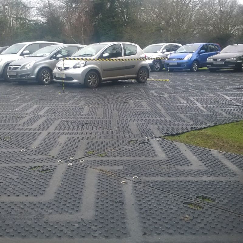 Euromat ground protection mat with cars parked on top in a field